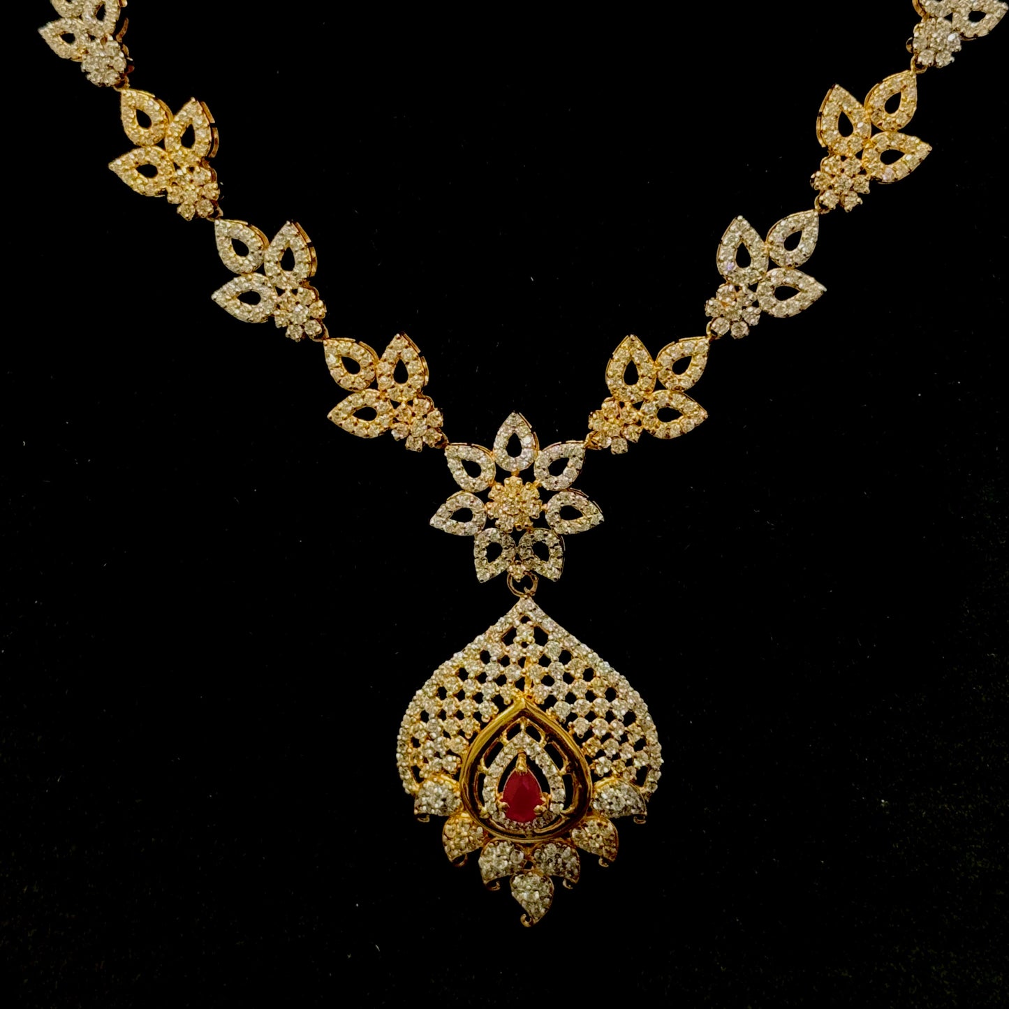 Glittering Cubic Zarconia Necklace with Singular Ruby Colored Stone