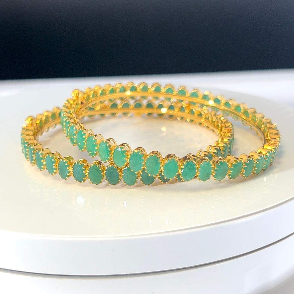Exemplifying Emerald Bangles
