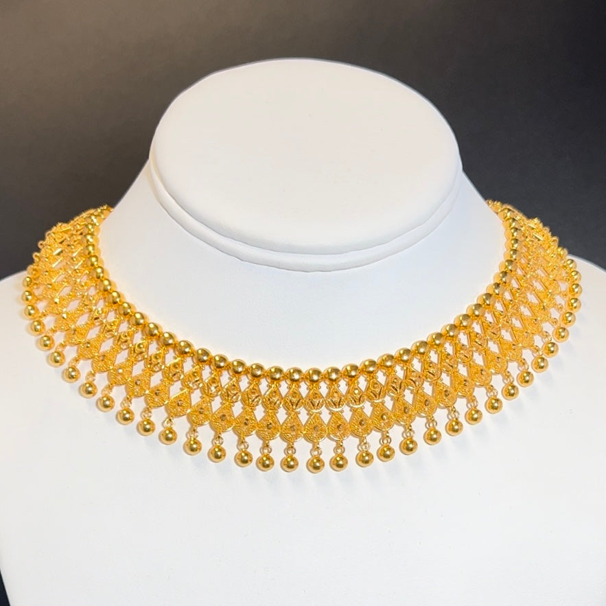 Splendid Choker Necklace with a Thick Design Featuring Several Golden Balls and a Pair of Royal Earrings
