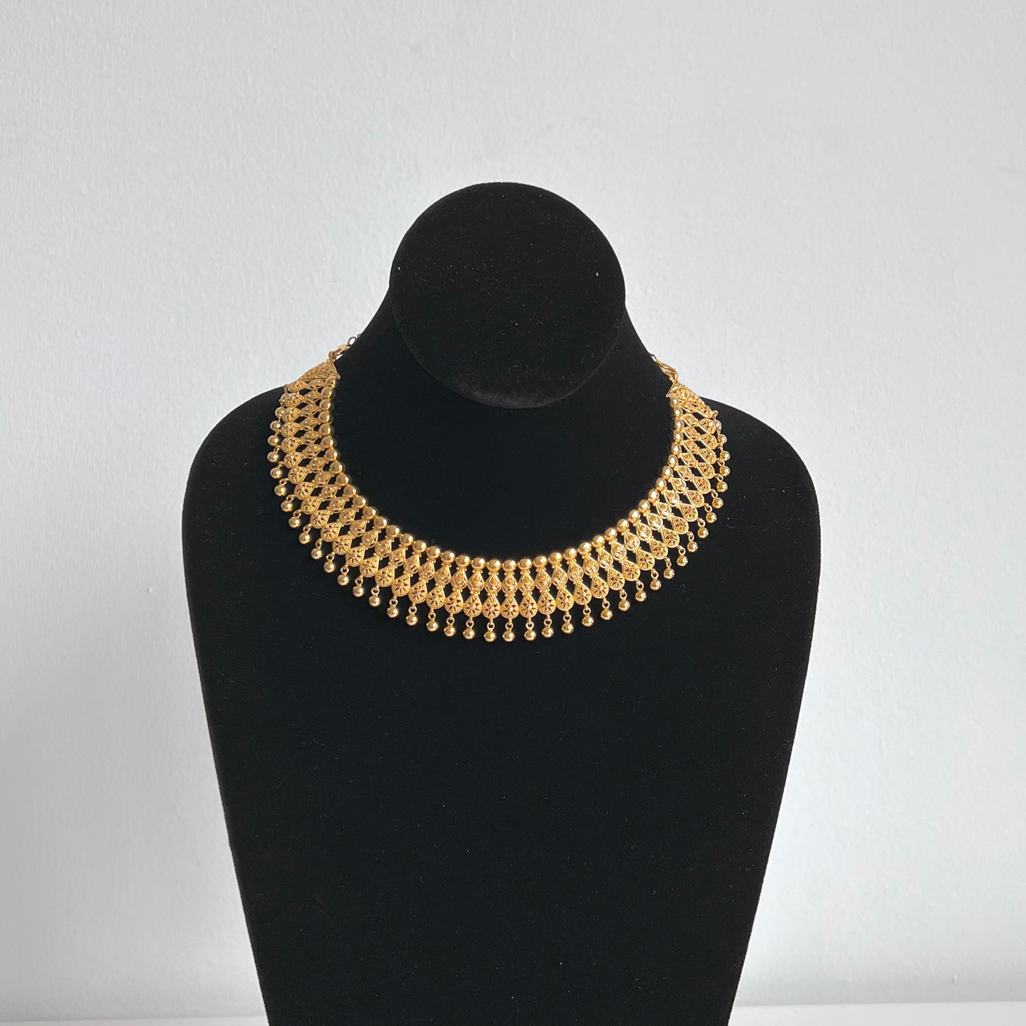 Splendid Choker Necklace with a Thick Design Featuring Several Golden Balls and a Pair of Royal Earrings